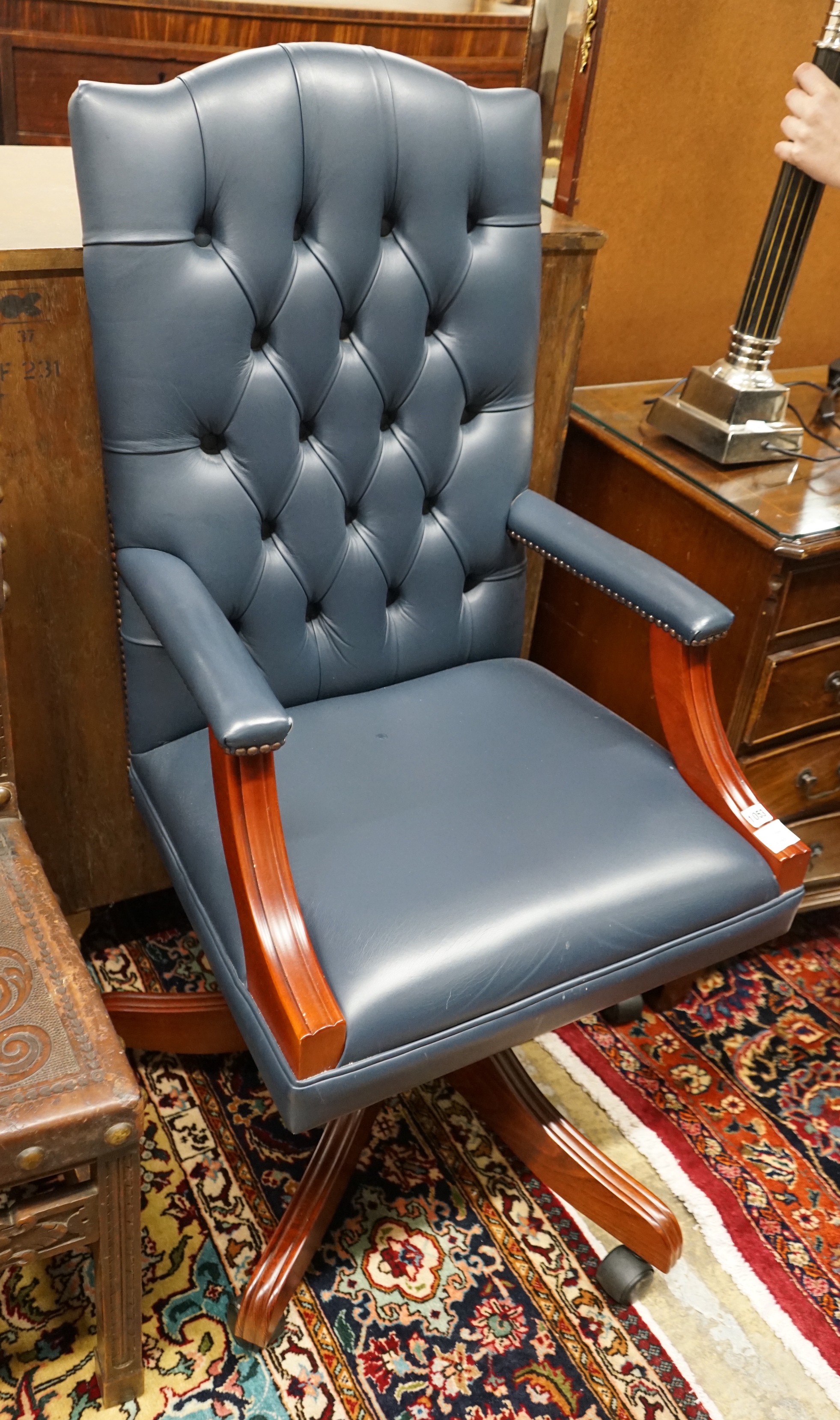 A Regency style mahogany blue buttoned leather swivel desk chair, width 58cm, depth 55cm, height 112cm